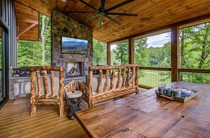 Located off of the kitchen is a large covered deck with a gas fireplace, blackstone, traeger grill and a dining table that seats 8-10.