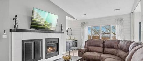 great room and fireplace with double electric recliner