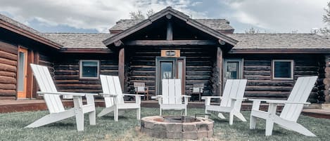 Courtyard with fire pit in the middle of the 3 main cabins