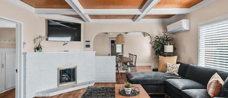 Spacious living room with plenty of seating featuring smart TV with streaming services