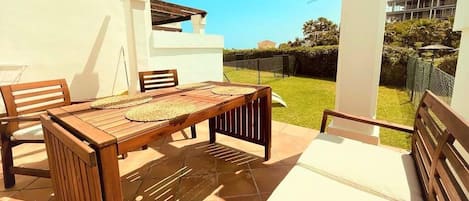 Terrace with outdoor seating/dining area and garden with sun loungers