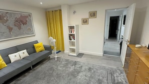 Living room with sofabed 3 seater. Extra blanket & pillows are provided.