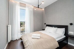 The cosy bedroom features a luxurious double bed and ample storage.
