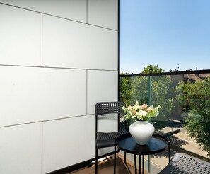 The balcony's stylish design complements the apartment's decor. 