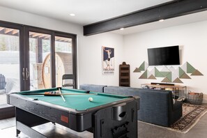 Step into the ultimate entertainment haven - the game room featuring a sleek pool table. This dynamic space is a paradise for both avid players and those seeking leisurely fun. The vibrant atmosphere is adorned with stylish decor, creating an energetic and inviting ambiance.