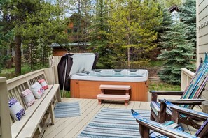 Ease sore muscles in the private hot tub located off of a spacious deck.