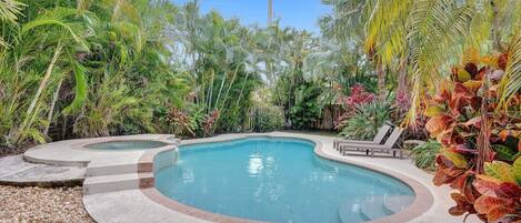 Beautiful heated pool with a lush tropical setting