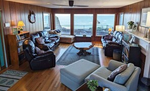 The common area library overlooks the ocean below. 