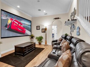 Enjoy movie nights in the cozy living room with plush recliners and a big-screen TV.