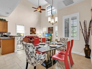 Dine in style in the bright and elegant dining area with high ceilings.