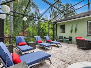 Unwind on comfortable lounge chairs in the sunlit outdoor patio.