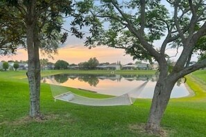 Idyllic Florida evenings are not complete without a beautiful view of the sunset overlooking the water in the backyard! You can also take a stroll around the pond!