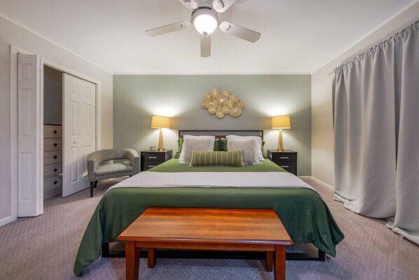 Primary bedroom with king bed, en-suite bathroom, and large closets