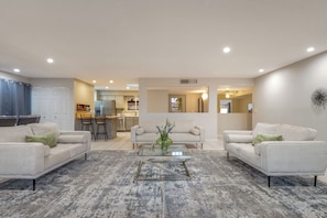 Beautiful, grand living room that leads to the dining area and kitchen