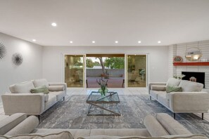 Grand living room with views of the patio and golf course