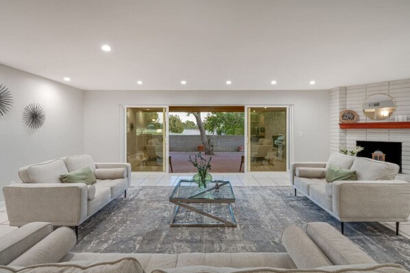 Grand living room with views of the patio and golf course