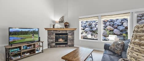 Living room w/ TV and fireplace