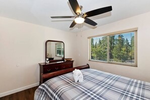 2nd bedroom with queen bed, dresser with vanity