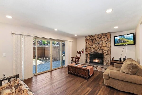 Living room with fireplace, cable TV, rocking chair