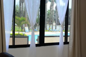 Large living room windows, overlooking the pool.