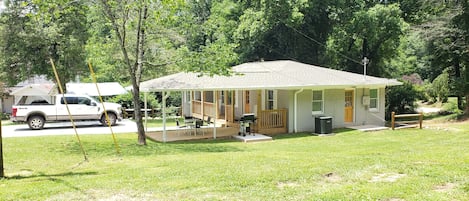 Outside View
Showing covered porch, sitting area, gas grill and large driveway 