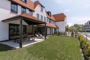 Private garden with terrace and sunbeds.