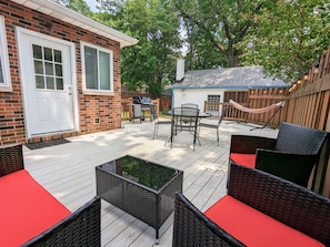 Large private patio featuring a grill, plenty of seating, and a hammock