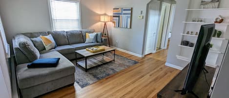 Cozy living room featuring 54" smart tv and large sectional sofa