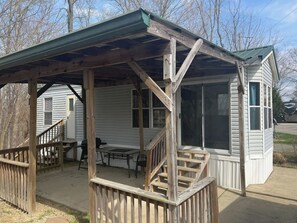 Patio with a table, chairs, and a BBQ grill for your use.