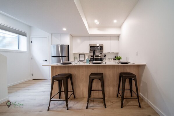 Kitchen bar stool seating in bright space