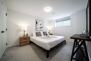 King size bed in room with dual closets for spacious storage