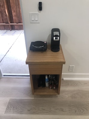 Coffee maker and hot plate.  Pots and pan, utensils, knives and cutting board.