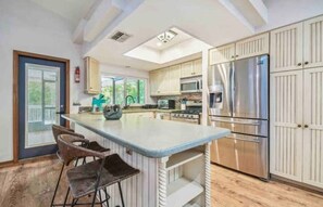 Gorgeous kitchen with huge pantry, custom cabinets, corian counters, stainless