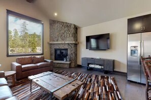 Cozy stone fireplace, featured in the living area