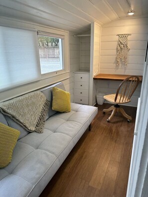 Cozy office has Room & Board folding futon and live edge redwood desk.