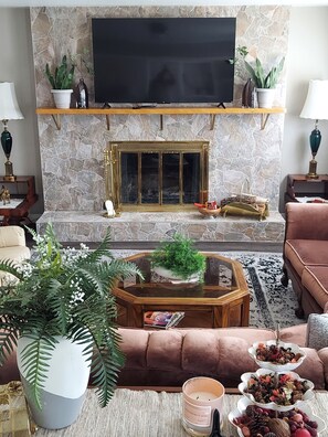 Family room with 60" Roku TV  Authentic wood burning fireplace. 