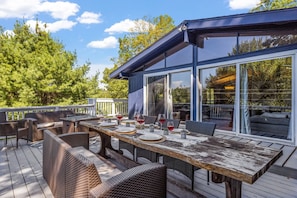 Huge wraparound deck with three grills. great for hosting an outdoor event