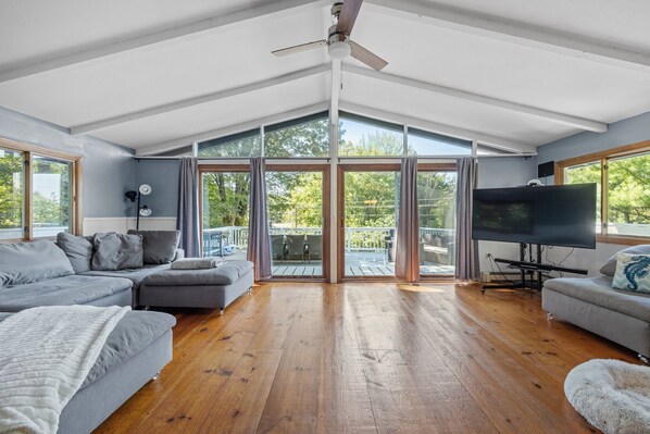 Spacious Living room with floor to ceiling windows with landscape views