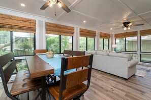 A dining table on the sunporch seats 7