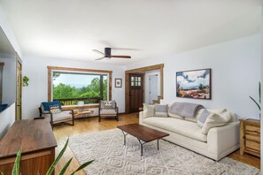 Living room with 60" SmartTV and access to the wraparound deck