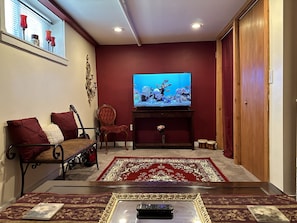50 inch smart TV in the living area adjacent to the bedroom.