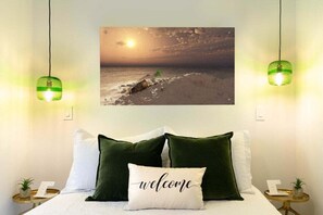 Relax in a room adorned with a queen bed and soothing green accents.