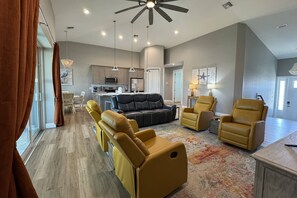 The main living area is an open concept with dramatic ceilings and includes the living, dining and kitchen spaces.