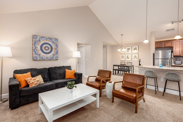 Spacious living area with vaulted ceilings and a super comfortable sofa.