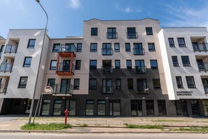 The exterior of the apartment building, showcasing its modern design and urban appeal.