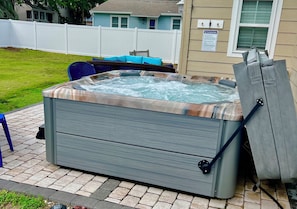 Relax in the hot tub in a private fenced in back yard