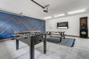 Game on! Enjoy endless entertainment with foosball, shuffleboard, darts, and board games in this stylish rec room—perfect for friendly competition and unforgettable memories!