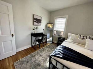 Bedroom 2: It also includes a desk where you can do some work before resting, along with a full-sized body mirror for quick checks before heading out.