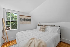 Light filled bedroom featuring a comfortable memory foam king sized bed