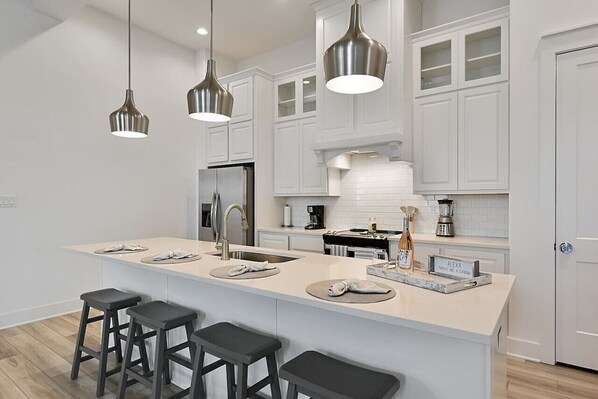 Close up view of the kitchen area island, you will notice some of the small appliances provided such as a blender and coffee maker - for more information view the whats included.